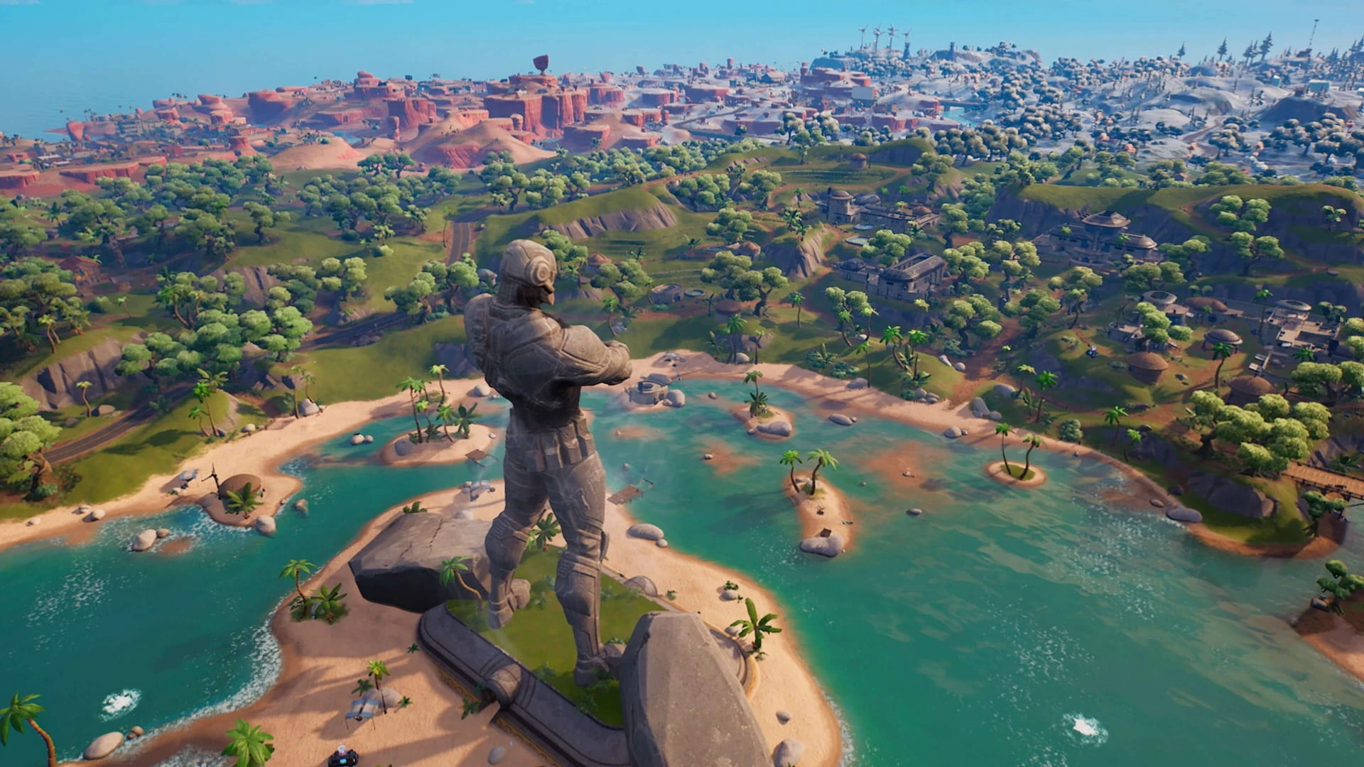 Vista aérea de la isla del capítulo 3: la estatua gigante de la Fundación sobre una bahía, con nieve y desierto al fondo