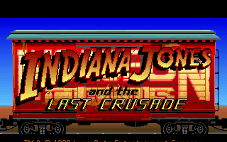 El logotipo de Indiana Jones and the Last Crusade superpuesto a un vagón rojo de circo, con el cielo azul y el desierto al fondo