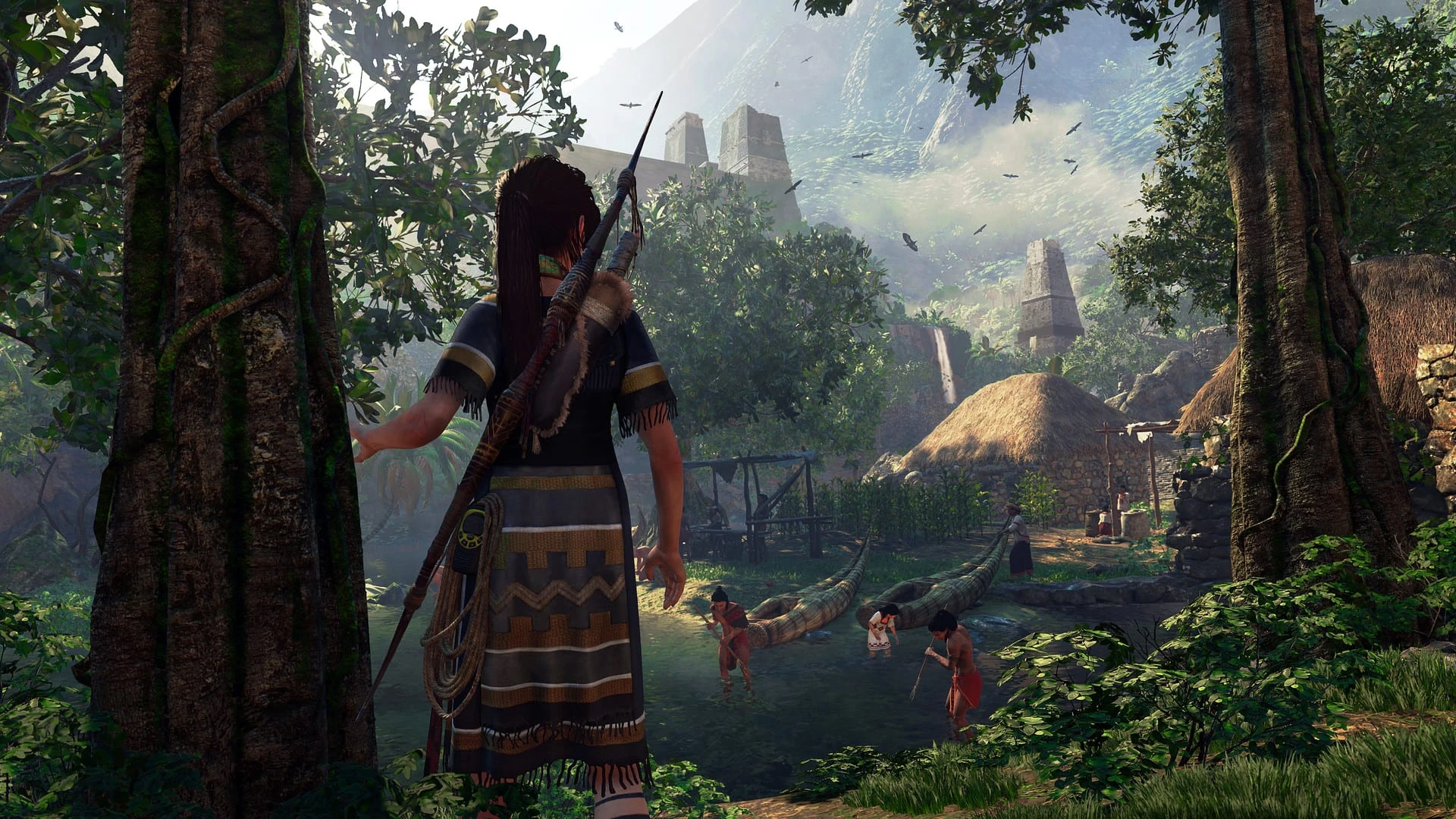 Lara Croft, con ropa tejida y un arco a la espalda, contempla desde la selva un poblado de chozas junto a un río