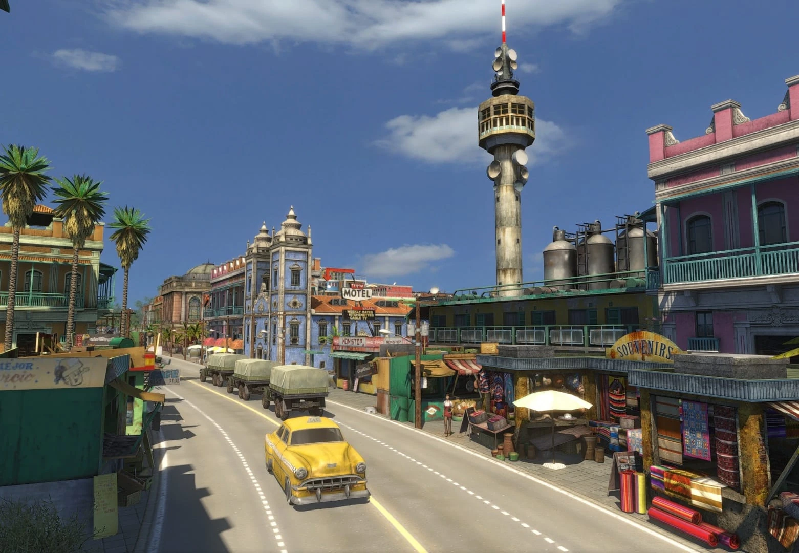 Avenida de una ciudad caribeña con un taxi amarillo, camiones militares, puestos de recuerdos y una torre de radio al fondo