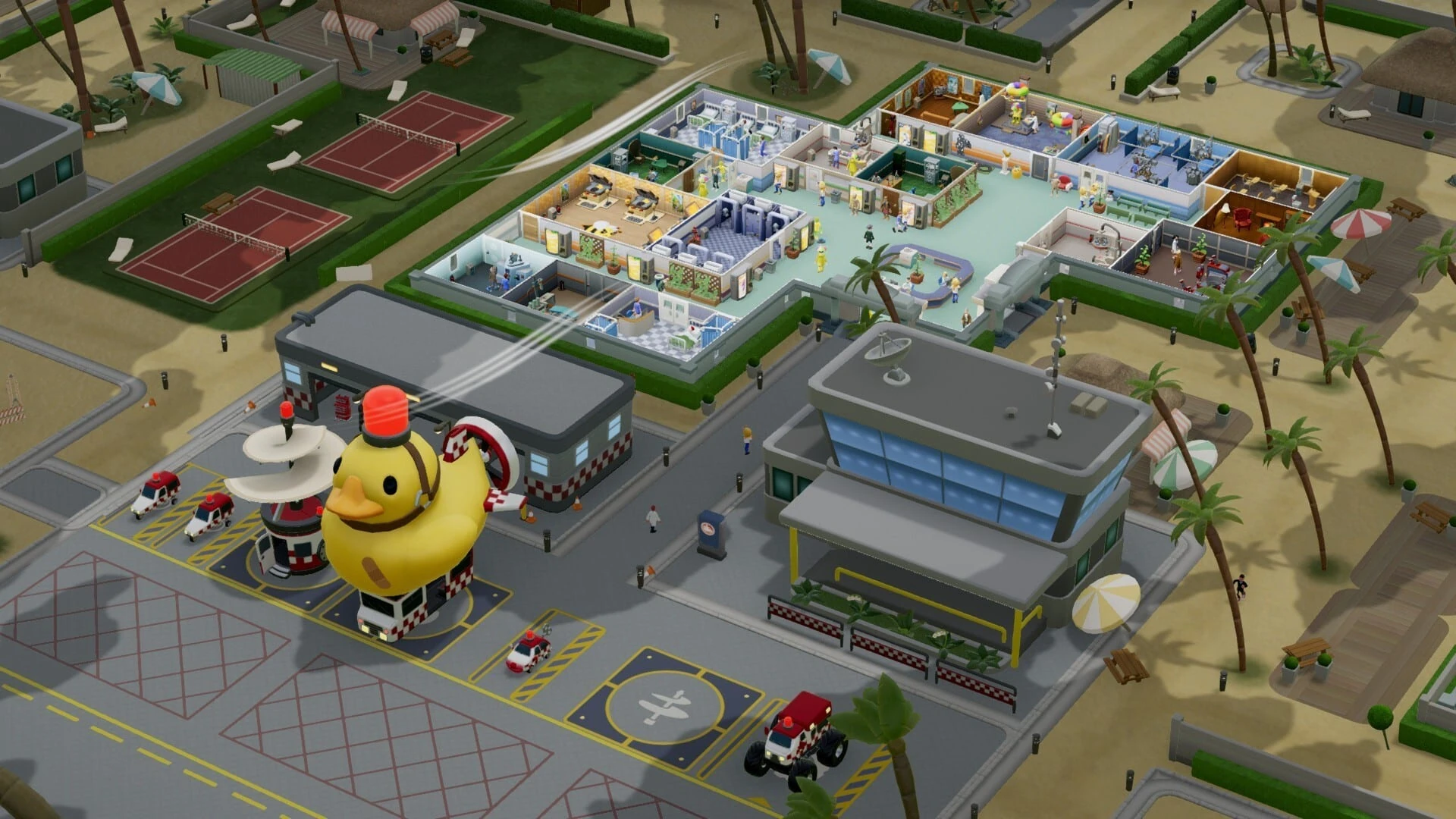 Una base de ambulancias junto al hospital, con un helipuerto, un pato de goma gigante con sirena y pequeños vehículos rojos aparcados