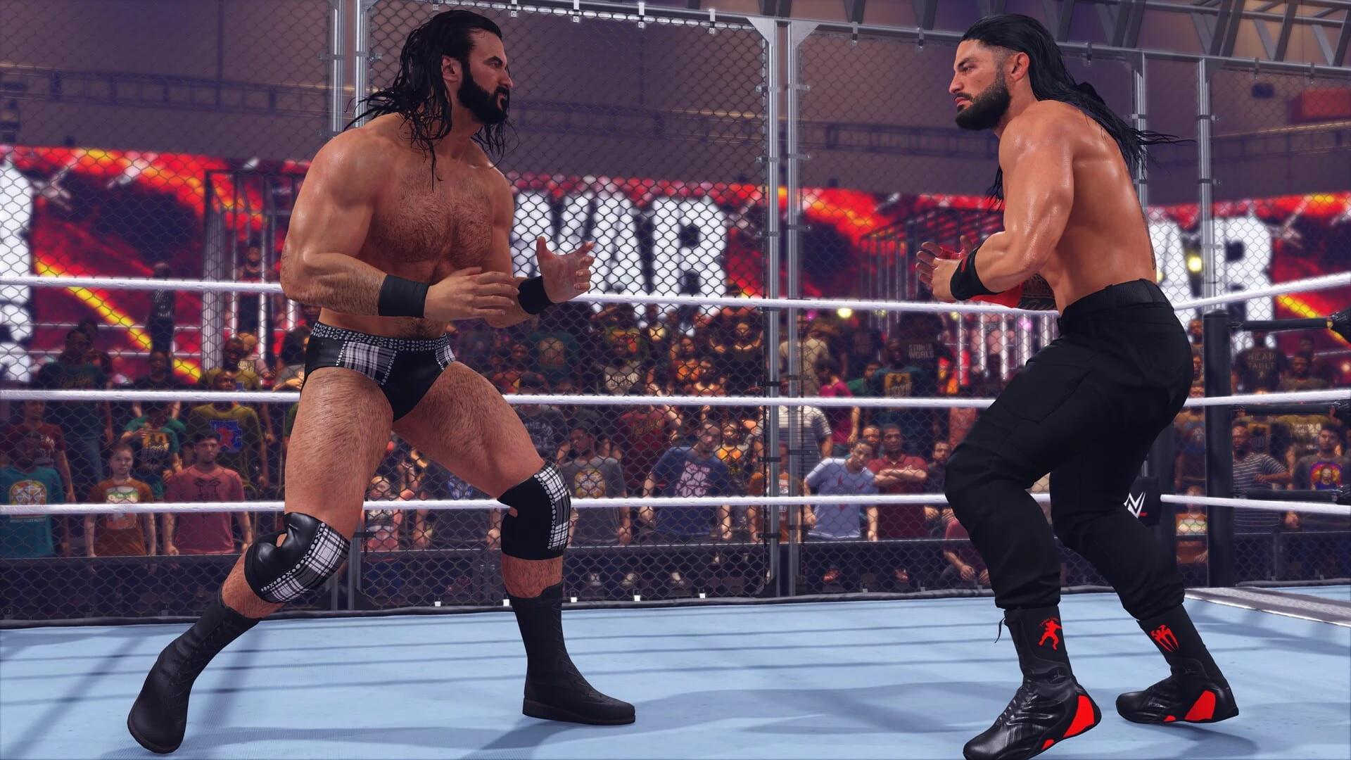 Dos luchadores se miran en guardia dentro de una jaula que rodea el ring, con el rótulo de WarGames detrás
