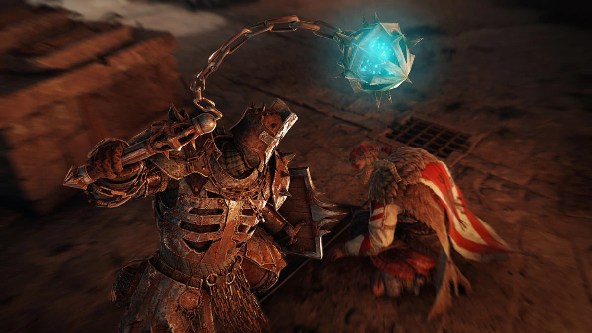 Captura de juego: el Guardián de Cadenas hace girar sobre su cabeza un mangual de púas que arde en azul, frente a un enemigo caído de rodillas en un suelo de ti