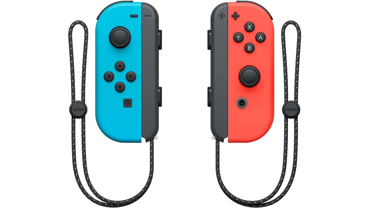 Los dos mandos Joy-Con de Nintendo Switch, el azul y el rojo, separados y con sus correas de muñeca colgando, sobre fondo blanco