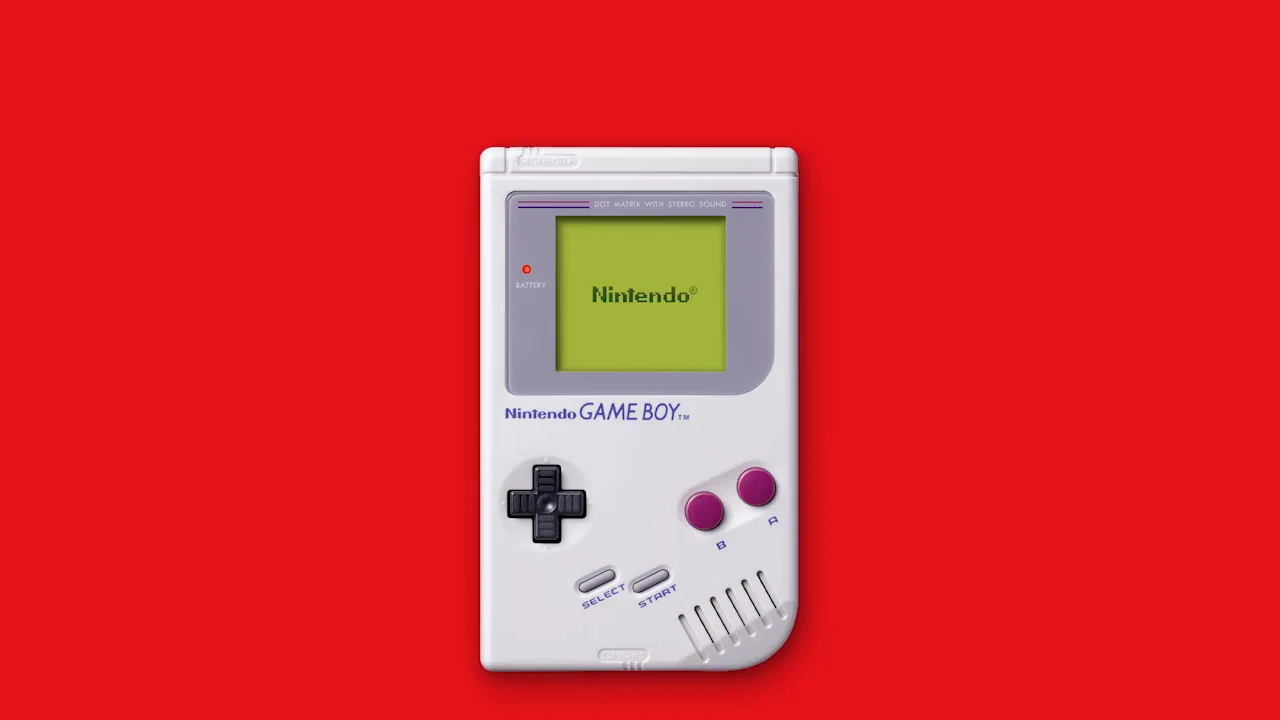 Una Game Boy original de color gris, con la pantalla verde encendida y el logotipo de Nintendo, sobre fondo rojo