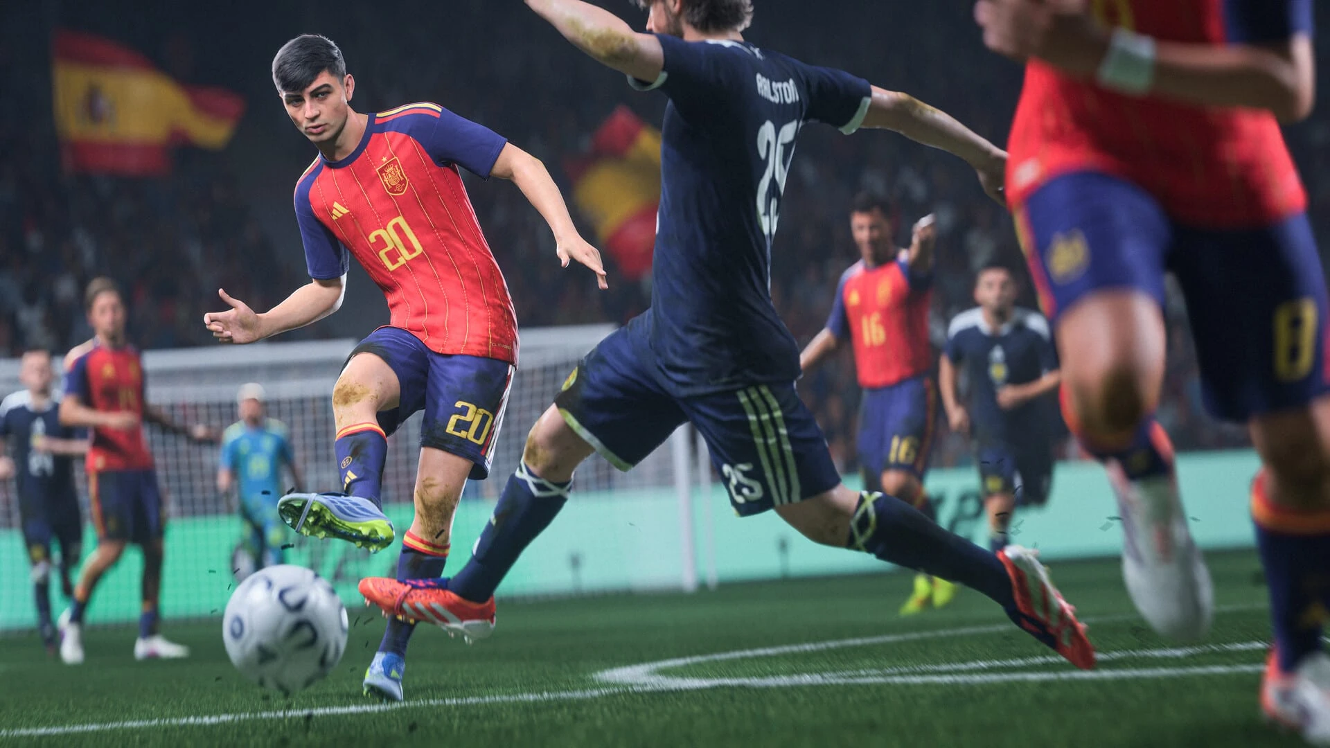 Pedri, con la camiseta roja de la selección española, golpea el balón mientras un defensa de Escocia entra a tapar